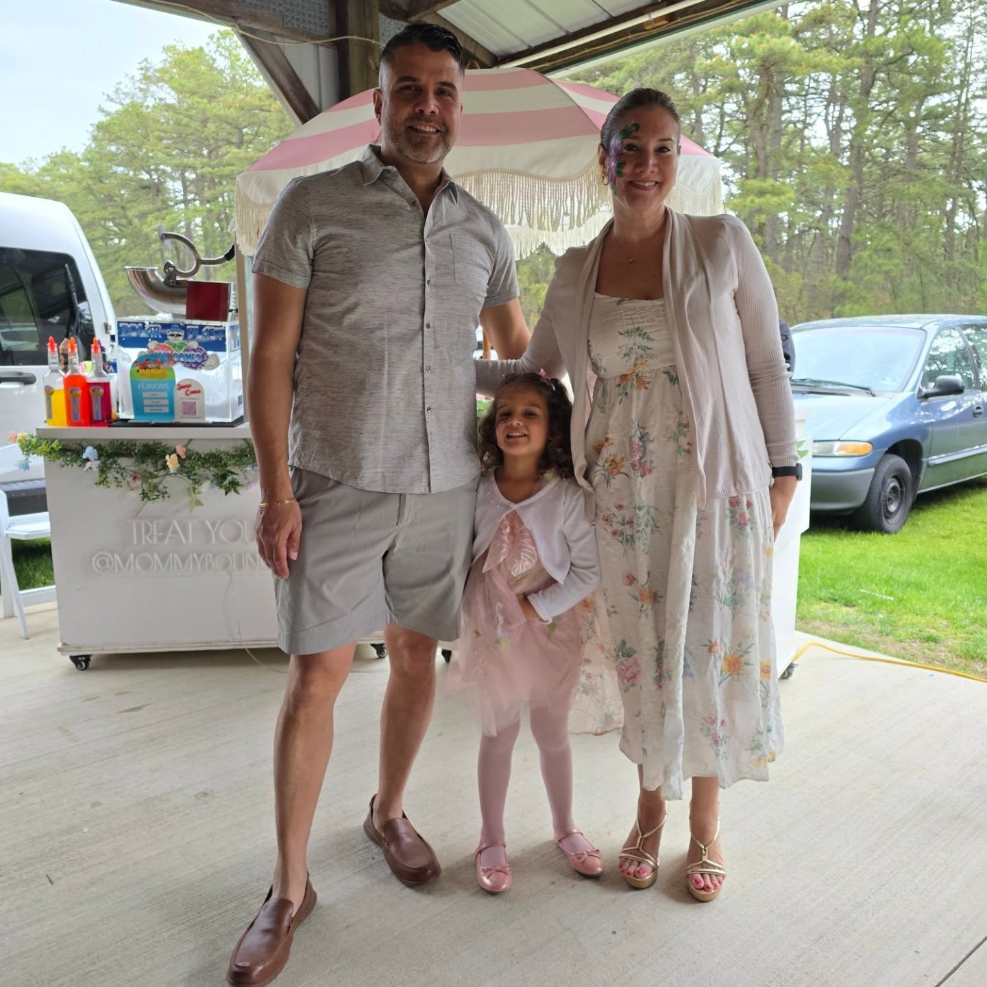 A family celebrating beside a Mommy Bounce World sweet-treat station