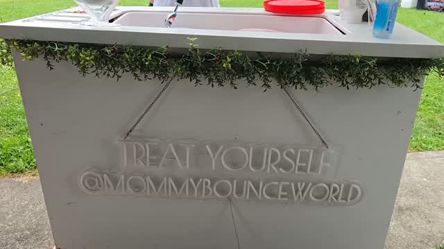 Mommy Bounce World treat cart with greenery and a Treat Yourself sign